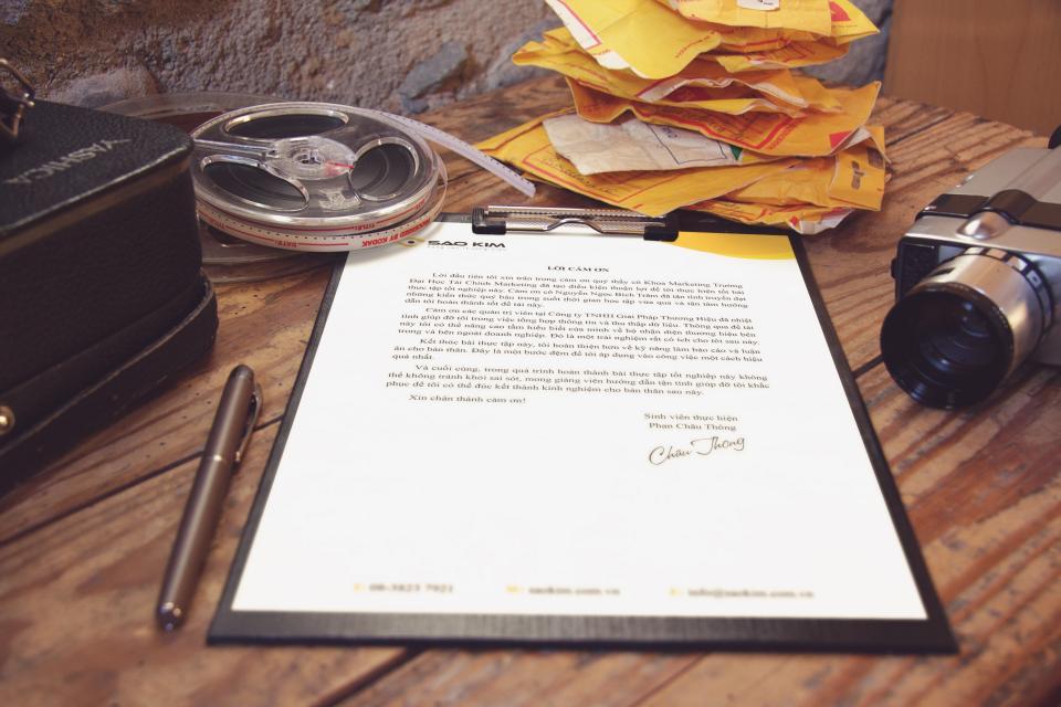 Signed contract and pen on a timber desk