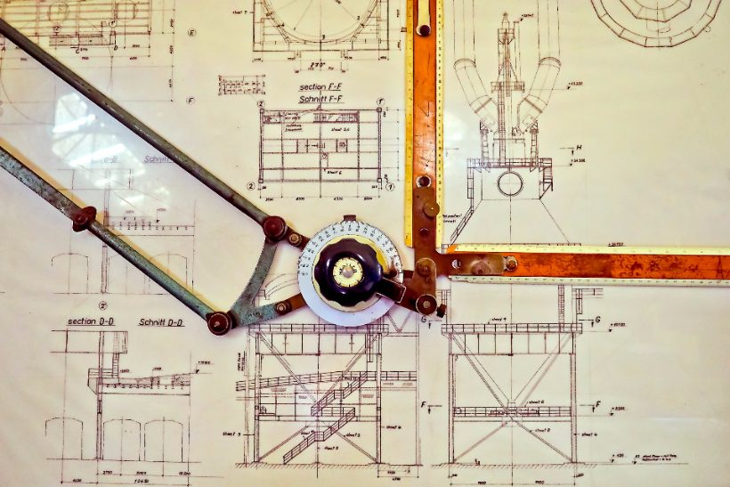 Builder marking up a set of construction drawings