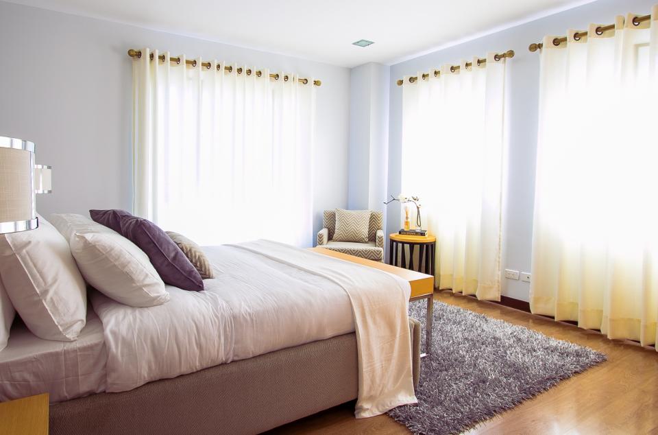 Bright new bedroom with tall windows and hardwood floor