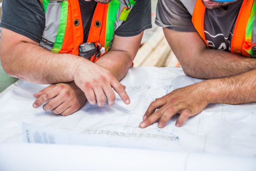 Two builders going over a set of plans together