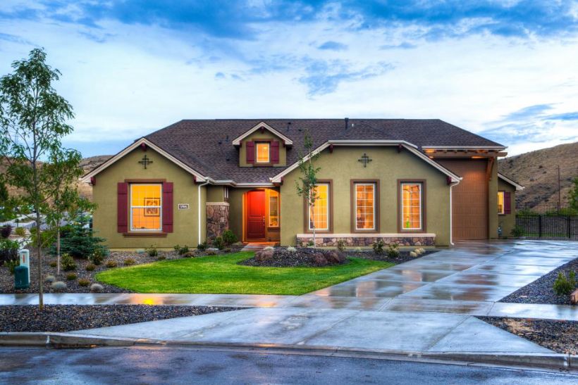 Single-storey home with stone accents and a new driveway at dusk