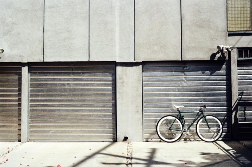 Row of garage doors with a bicycle leaning outside