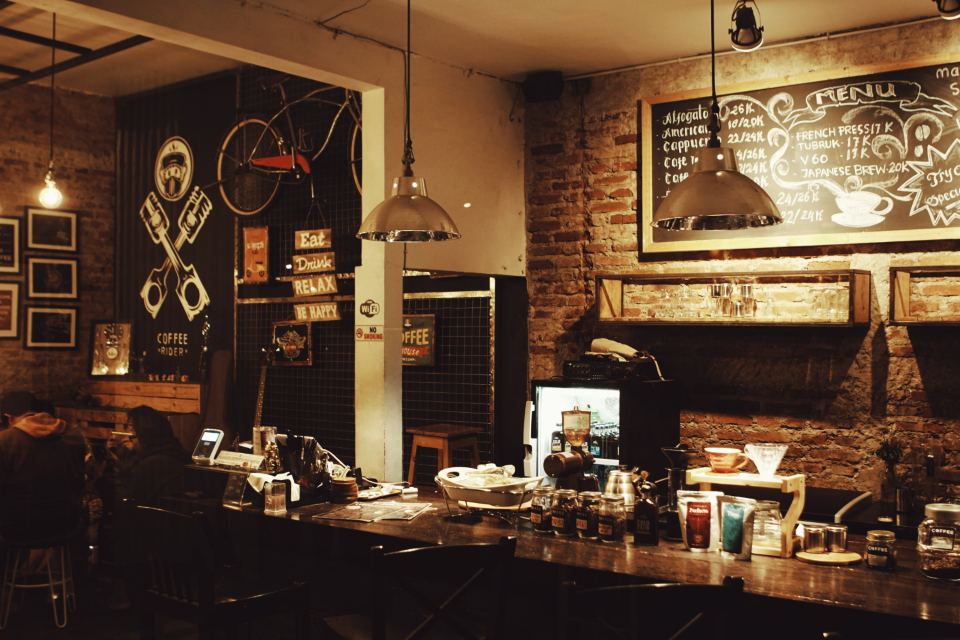Coffee bar counter lit by low pendant lamps