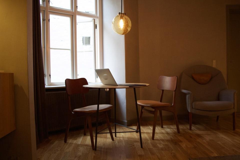 Quiet cafe corner with timber chairs by a window