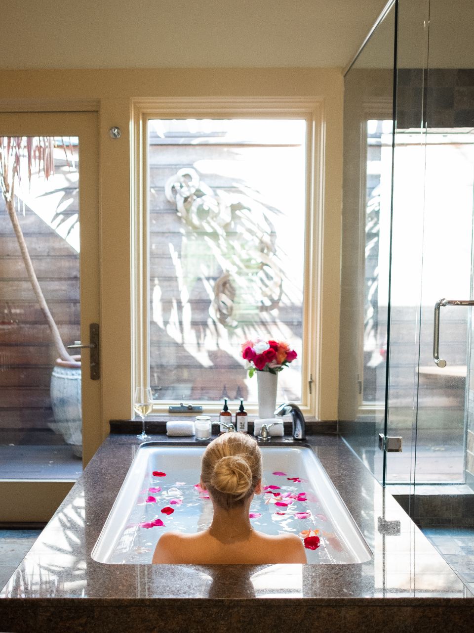 Spa soaking tub scattered with rose petals