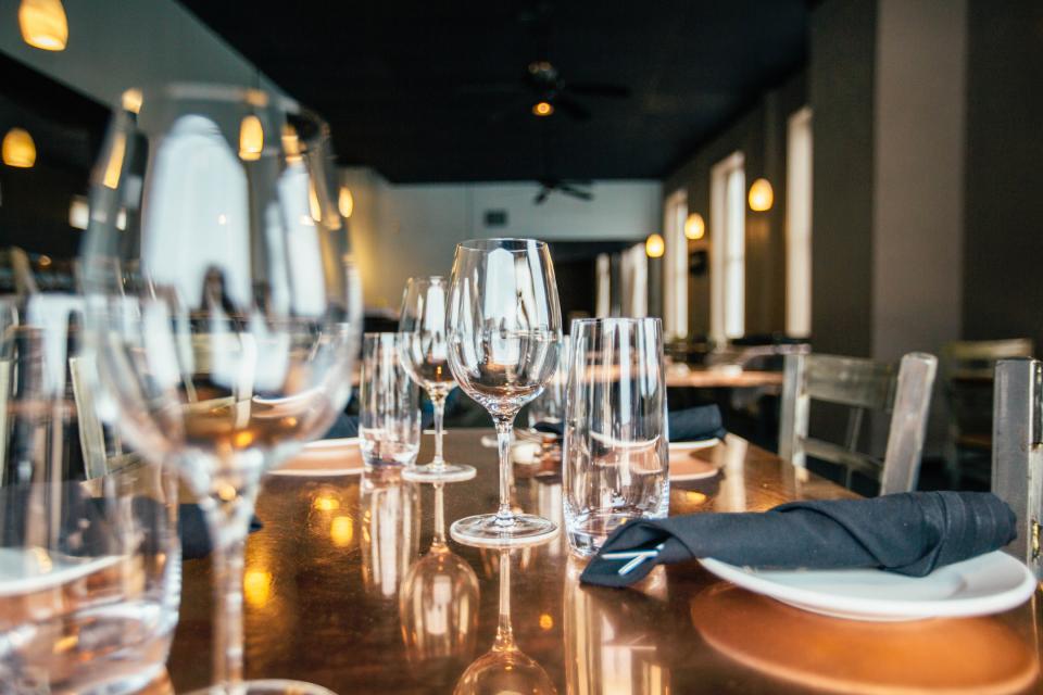 Restaurant table set with wine glasses in warm light